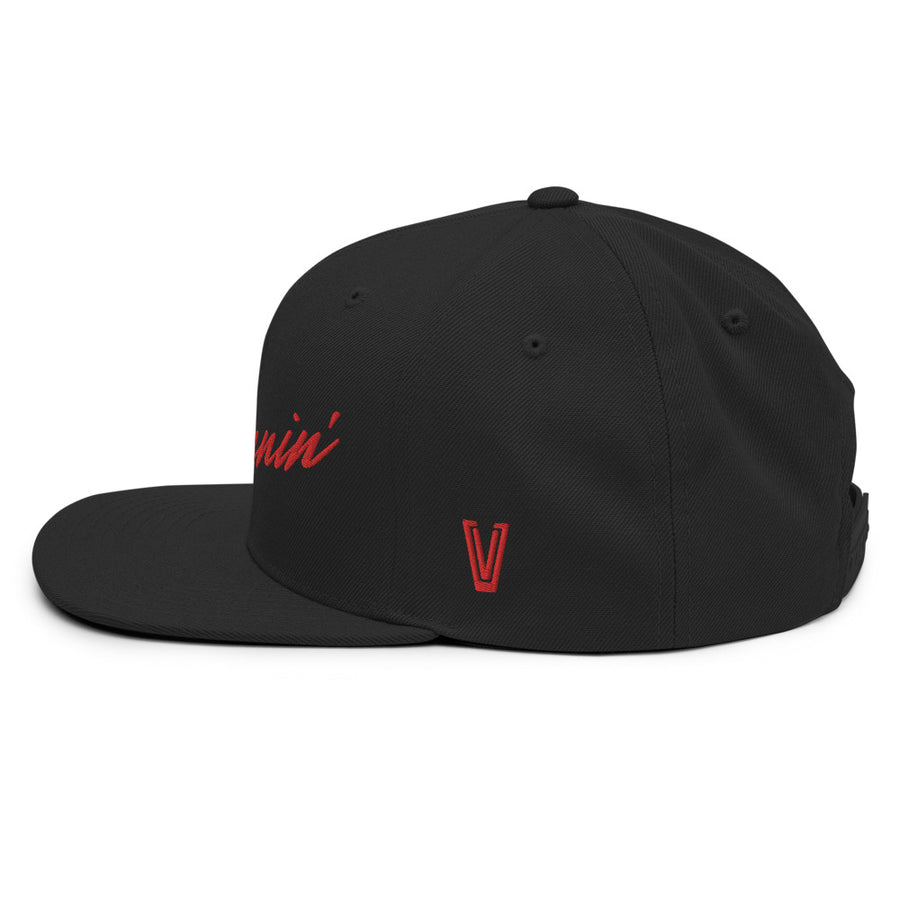 Left side profile of black snapback UNLV Runnin' Rebel basketball hat with vintage style Runnin' in red script
