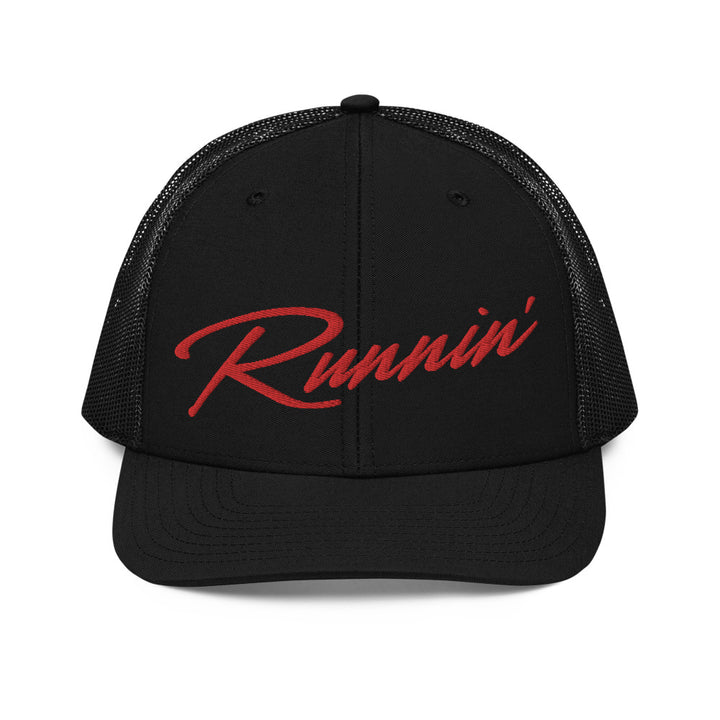 Front profile of black snapback UNLV Runnin' Rebel basketball trucker hat with vintage style Runnin' in red script